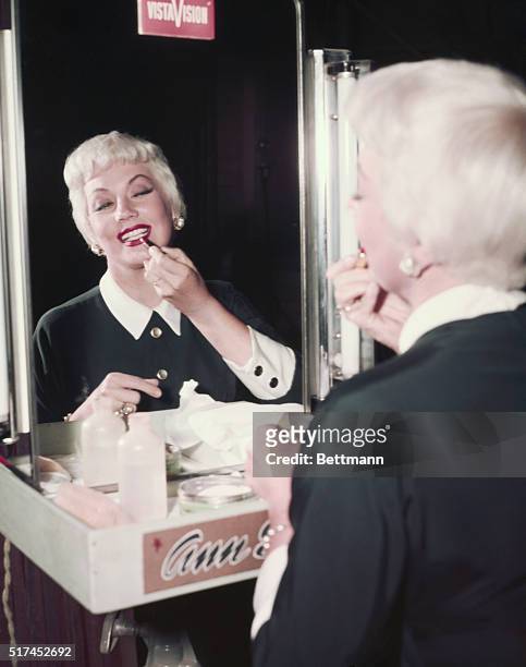 Ann Southern touches up her own lipstick here before resuming her part as Susie McNamara on the CBS-TV show Private Secretary. Note the new hair do.