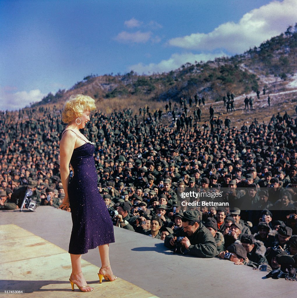 Marilyn Monroe Posing on Stage in Front of Troops
