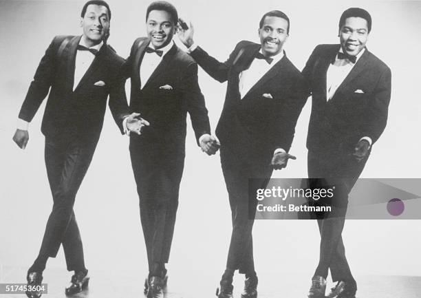 The Four Tops singing group together in one of their dance moves that they did when they sang.