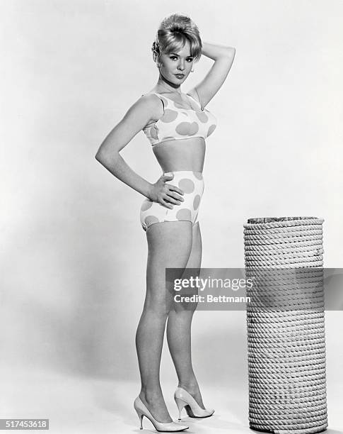 A YOUNG BLOND POSES IN A TWO PIECE BATHING SUIT. AN UNDATED PHOTO.