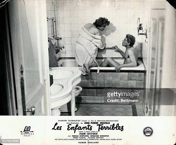 Scene from the 1950 production of Jean Cocteau's novel "Les Enfants Terribles" showing actress Nicole Stephane getting into a bathtub with actor...