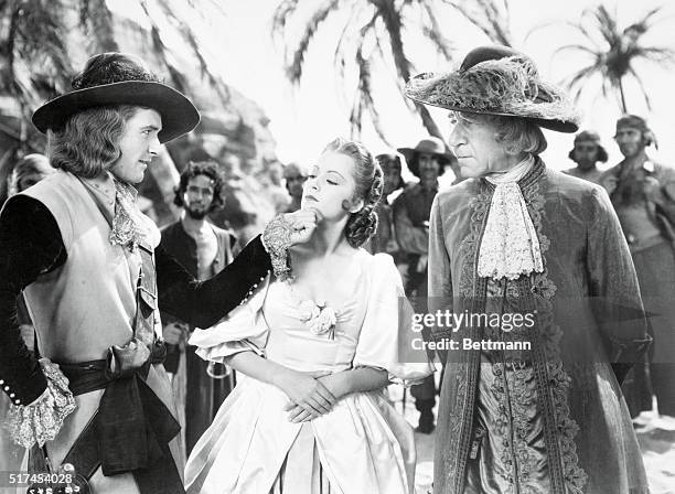 Henry Stephenson, Olivia de Havilland, and Errol Flynn is scene from Warner Brothers drama Captain Blood, 1935.