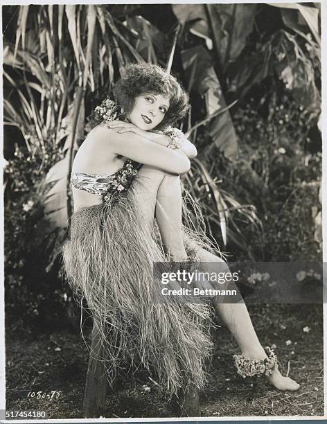 Actress Clara Bow seated and in a jungle costume from an unidentified film. No other information is available.