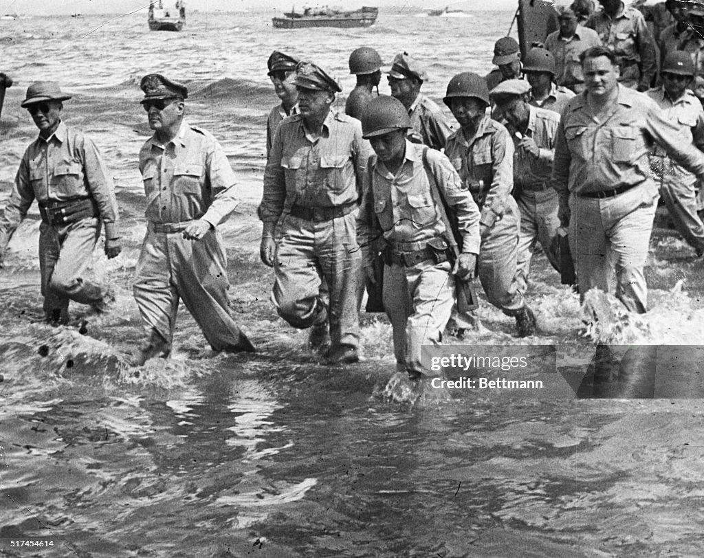 General Douglas MacArthur Walks To The Shore Of Leyte Island With A general-douglas-macarthur-walks-to-the-shore-of-leyte-island-with-a