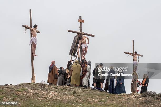 An actor portraying Jesus is crucified as residents of Hiendelaencia dressed in period clothing perform during the reenactment of Christ's suffering...