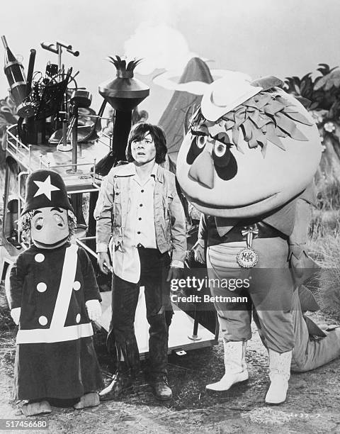 Cling , Jimmy and Mayor H.R. Pufnstuf watch forlornly as the witch-in-residence of their island flies away with Jimmy's magical talking flute.