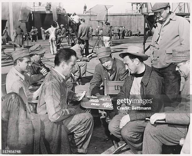 Chick Chandler, Humphrey Bogart, Richard Travis and Murray Alper play a strenuous game of cards between scenes for Warner Bros. Production The Big...