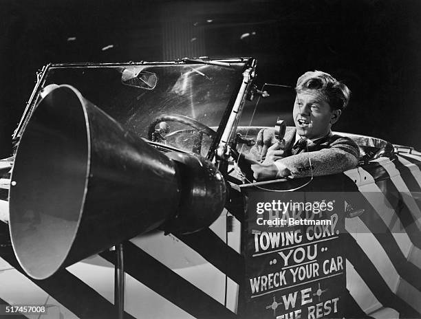 Mickey Rooney is riding in his car in scene from the MGM picture The Courtship of Andy Hardy.