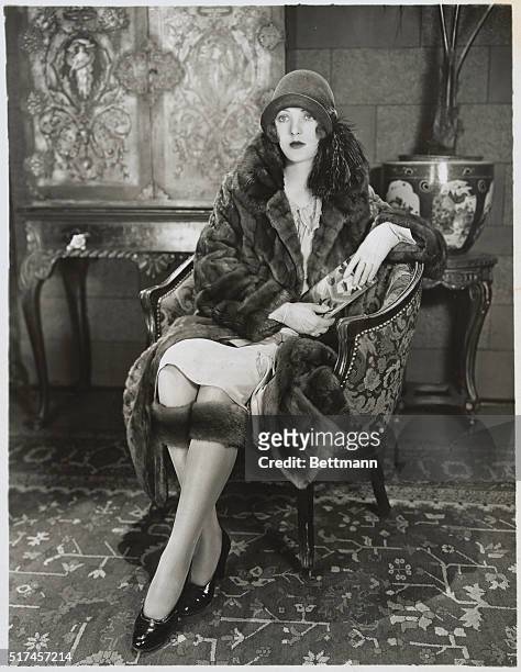 Here's Dorothy Mackaill, First National's famous anti-fat star, in a new sensation -- knee muffs -- which now promise to be the winter fashion rage...