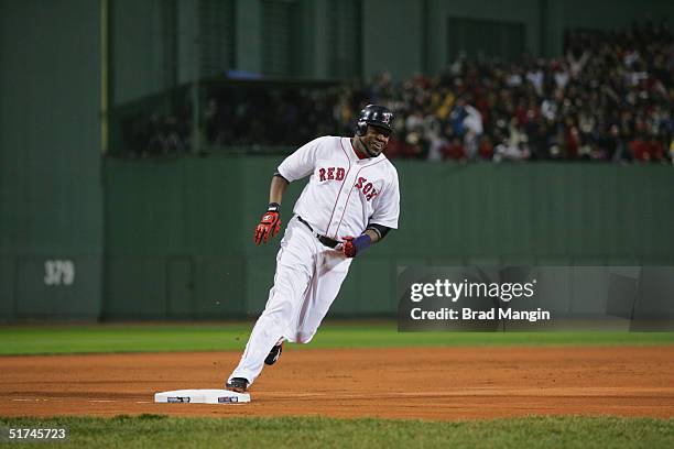 David Ortiz of the Boston Red Sox runs home to score after Jason Varitek's two run triple in the first inning during game two of the 2004 World...