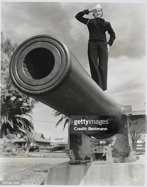 "Spirit of the Glorious Fourth." Irene Hervey, Metro-Goldwyn-Mayer featured player, in a symbolical pose atop this cannon, which was erected in the...