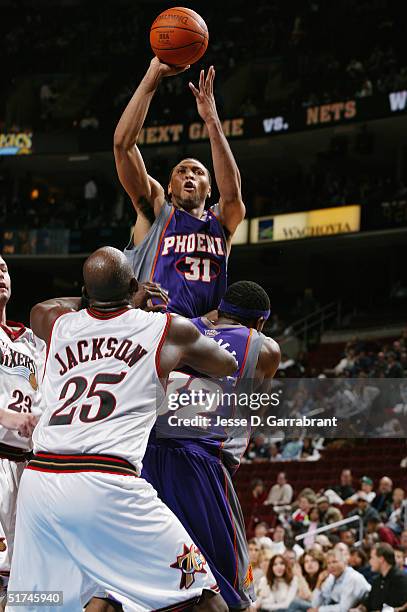 Shawn Marion of the Phoenix Suns shoots over Marc Jackson of the Philadelphia 76ers on November 5, 2004 at the Wachovia Center in Philadelphia,...