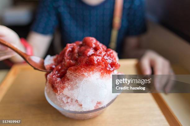 woman eating the shaved ice with mixed berries - かき氷 ストックフォトと画像