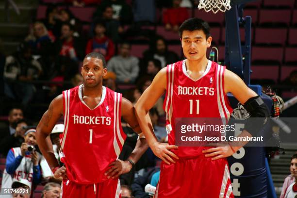 Tracy McGrady and Yao Ming of the Houston Rockets wait down court against the New Jersey Nets on November 15, 2004 at the Continental Airlines Arena...