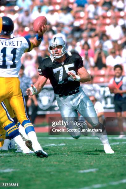 Defensive end Howie Long of the Los Angeles Raiders heads for the quarterback in a 20 to 17 win over the Los Angeles Rams on .