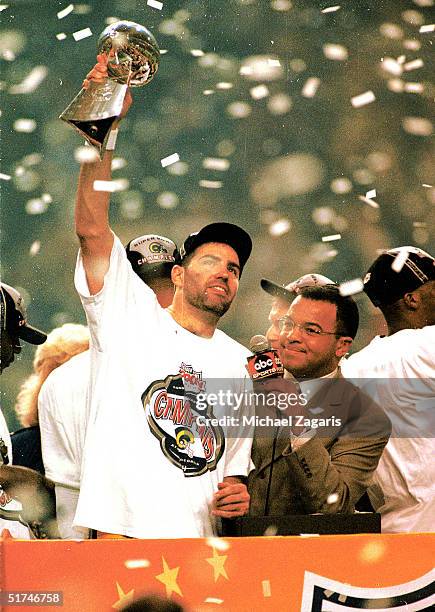 Quarterback Kurt Warner of the St. Louis Rams holds the Lombardi trophy high in the air after defeating the Tennessee Titans 23 to 16 in Super Bowl...