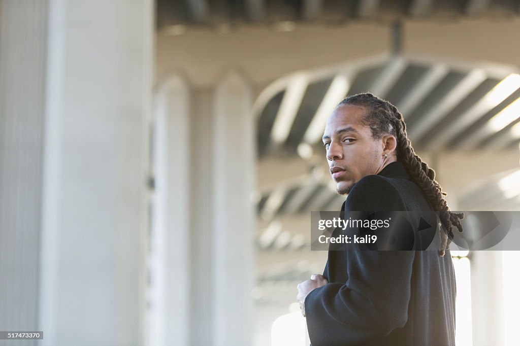 Young mixed race man staring with serious expression