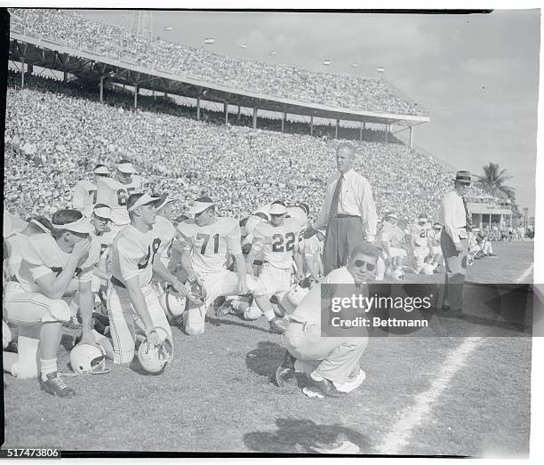 Coach Bud Wilkinson makes a tour of his players on the sidelines during the first half of their meeting with Maryland, as Oklahoma trails, 6-0, in...