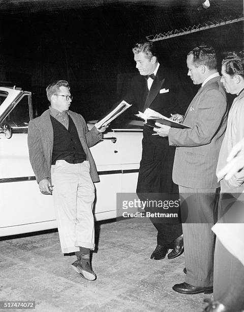 California: Mickey Rooney as Director at Columbia Studios In 1956 for a rehearsing scene with star Willard parker, while dialogue director James...