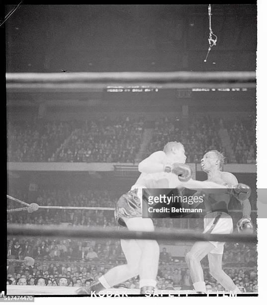 Lightweight Larry Boardman , of Marlboro, Conn., jolts featherweight champ Sandy Saddler with a whistling left hook in the 9th round of their bout at...