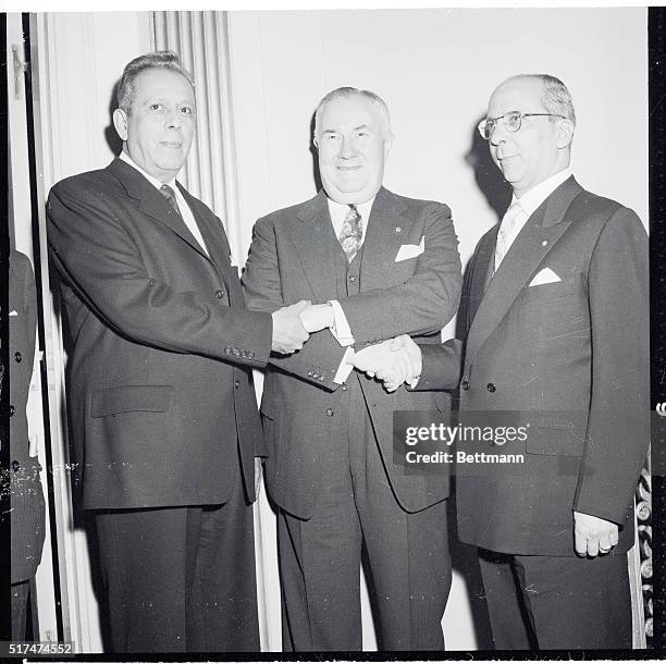 Sharing a three way handshake at the April 16th Luncheon for the Pan American Society of the United States to observe Pan American Day and to honor...