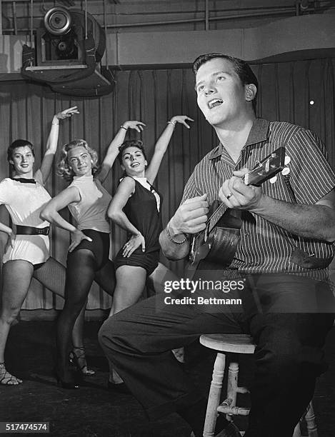 Pat Boone runs through a routine with the dance group of ABC-TV's The Pat Boone Chevy Showroom.