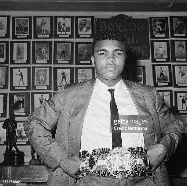 The belt emblematic of the world's heavy weight boxing championship is proudly displayed by titleholder Cassius Clay, September 17. Cassias, who...