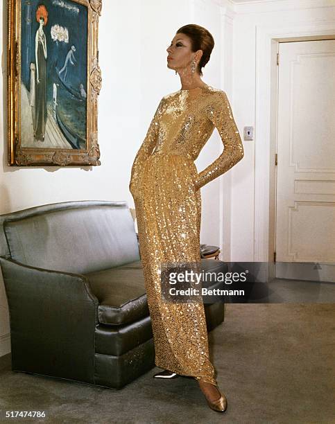 Sleek reflection...Adding sparkle to the feminine wardrobe this season, Norman Norell presented this sleek sequined gown in his Fall-Winter...