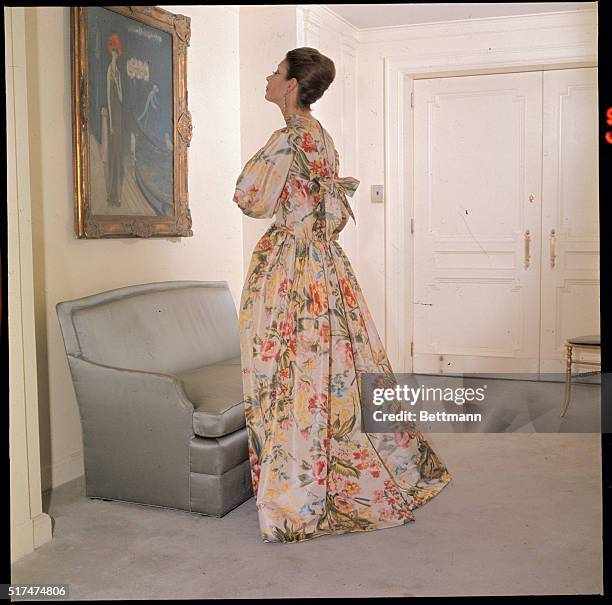 Flowers for milady...Norman Norell offers flowers to milady with this soft yellow, floral printed, housegown from his Fall 1963 collection. New...