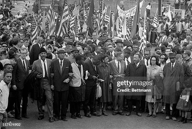 Dr. Martin Luther King leads an estimated 10,00 or more civil rights marchers out on the last leg of their Selma-to-Montgomery march. Others...