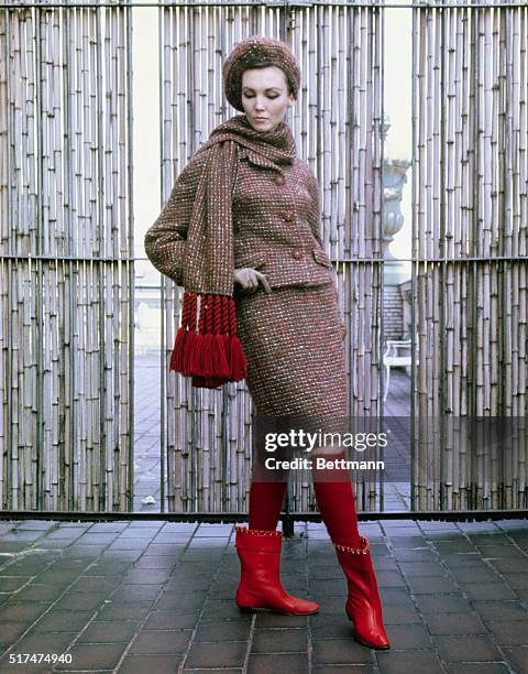 Over the knee, patterned tights are done in bubbly red mohair which fits elegantly under calf high boots. Here, socks underscored a stoled suit of...