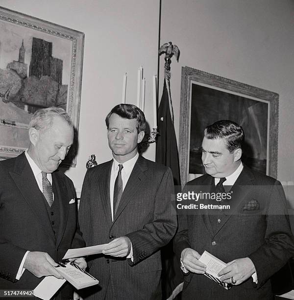 Encyclopedia Britannica publisher William Benton, a former Senator, hands a check to Senator Robert Kennedy. The check is the proceeds for a book, A...