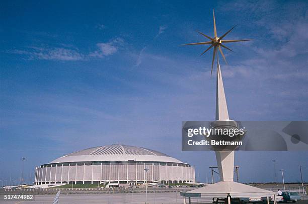 Giant gold abstract star tops the tower dominating an entrance to Houston's "Eight Wonder of the Modern World." It's the city's new Astrodome Stadium...