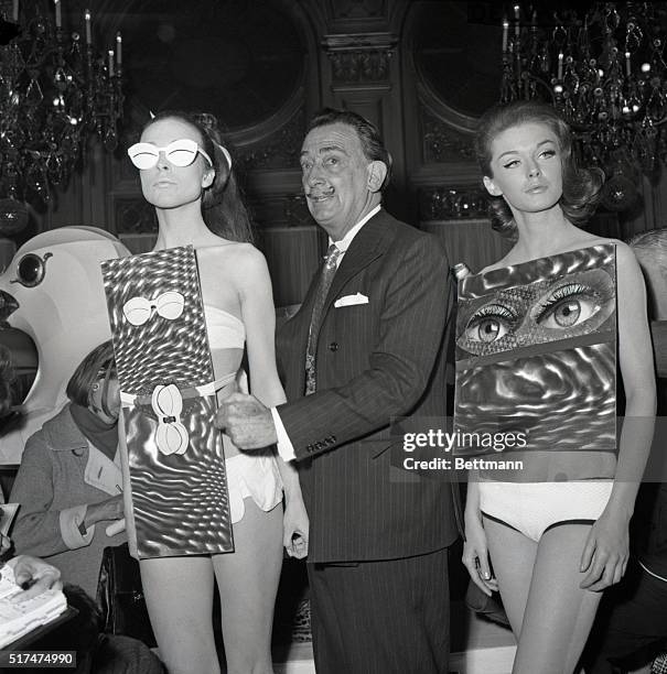 Artist Salvador Dali checks models wearing Dali-designed bathing suits during May 4th fashion show featuring his debut as couturier. The Dali...