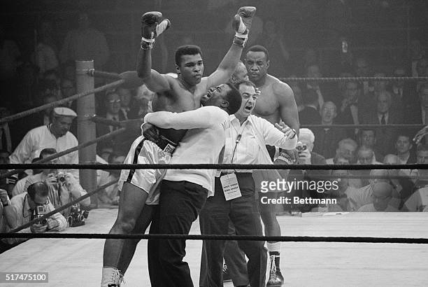 Heavyweight champion Muhammad Ali is lifted in jubilation after his match with boxer Sonny Liston. Clay knocked out Liston in the first round of the...