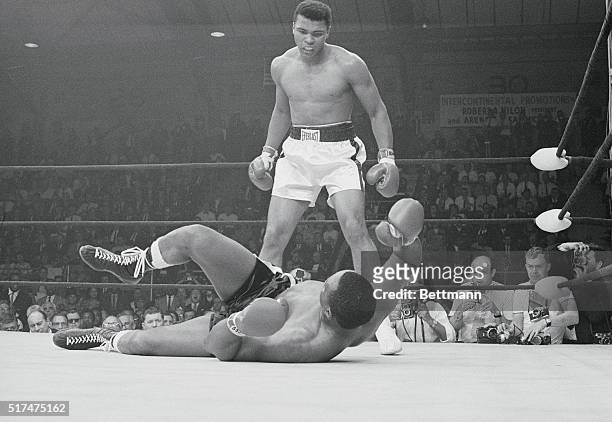 Lewiston: Heavyweight champion Cassius Clay stands over the downed Sonny Liston and taunts him after knocking him out in the first round of their...