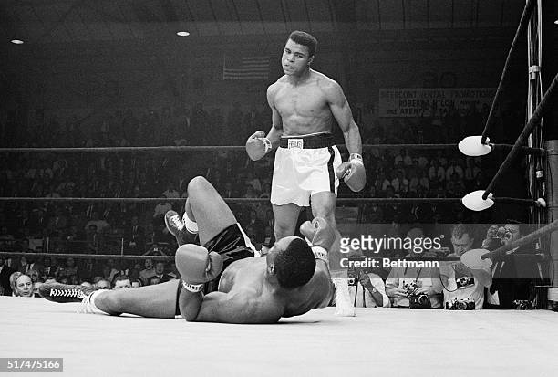 Boxer Muhammad Ali stands over boxer Sonny Liston after knocking him down during the first round of their match. Clay won the May 25, 1965 fight and...