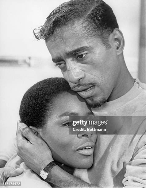 Sammy Davis, Jr. Clutches co-star Cicely Tyson towards him during a tender scene from the film "A Man Named Adam." Movie Still.