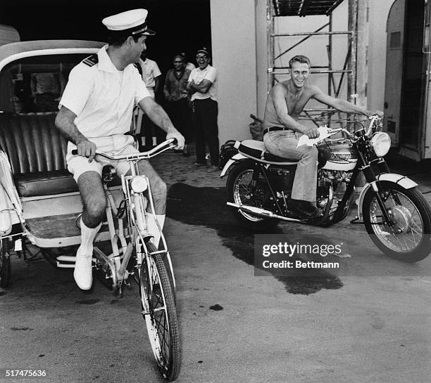 Thrilled over the arrival of his personally inscribed pedicab, Richard Crenna takes time off from the filming of 20th Century-fox's "The sand...