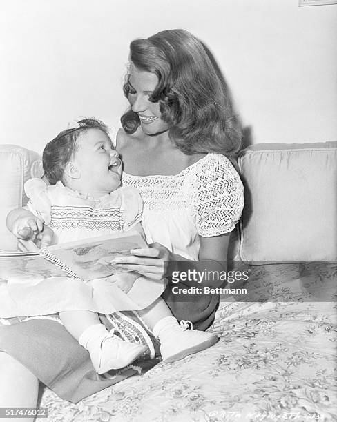 Prominent American film star Rita Hayworth is shown here spending time with her daughter, Rebecca Welles.