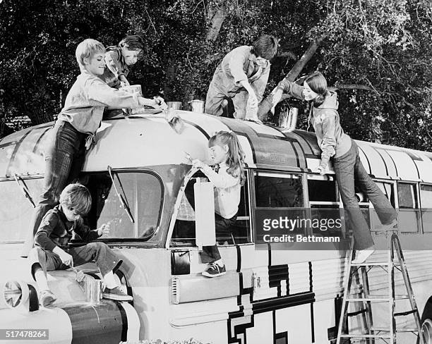 Scene from The Partridge Family television show where cast members are wildly painting their tour bus.
