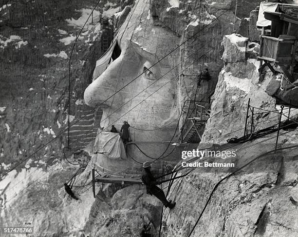 Mt. Rushmore, South Dakota: Working on the head of Jefferson: The man in the foreground is on Lincoln's head. Undated photograph, ca. 1940s.