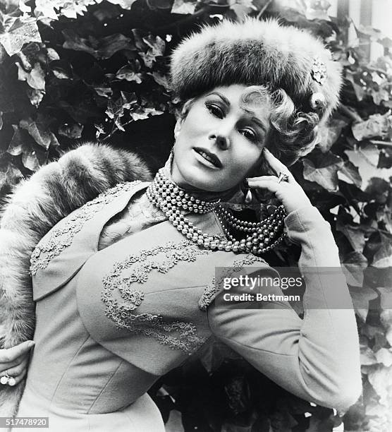 Hungarian actress Zsa Zsa Gabor wearing a pearl necklace and a fur hat.