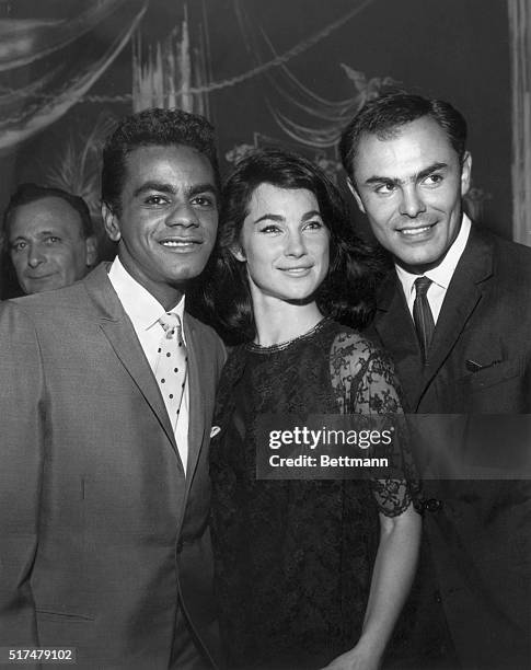 Johnny Mathis is being congratulated on his most successful opening night at the plush Cocoanut Grove in Hollywood by his friends and admirers...