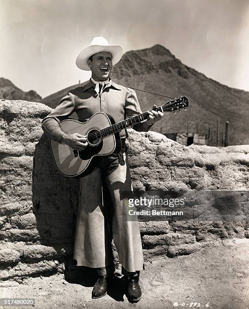 Gene Autry sings The Last Roundup from his own movie production of the same name. A western musical for Columbia release, it was filmed on location...