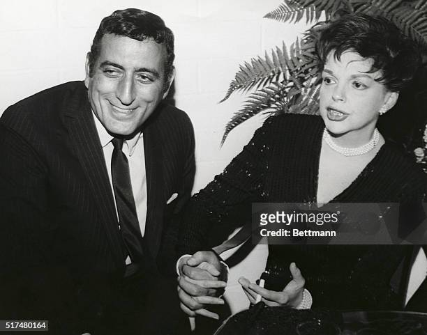 Two of America's great singers meet back stage as the fabulous Judy Garland congratulates singer-actor Tony Bennett during a Hollywood supper club...