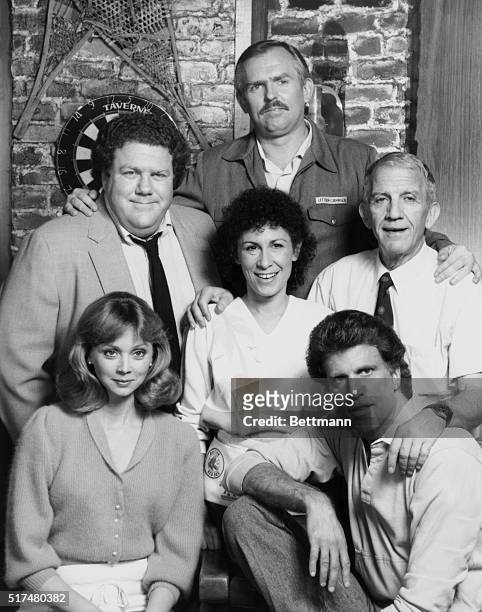 The cast of Cheers pose together in character. From left to right starting with the front row are: Shelly Long, as bartender Diane Chambers; Ted...