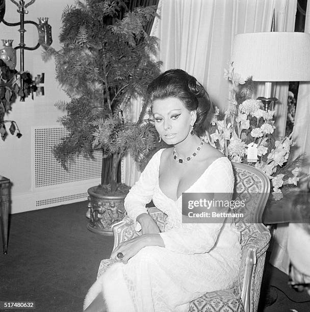 Looking happy before setting out to attend the premiere of "Dr. Zhivago," Italian actress Sophia Loren and producer Carlo Ponti relax at their New...