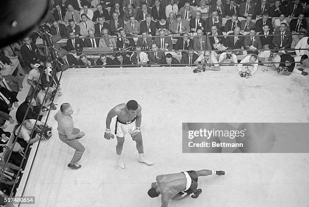 Floyd Patterson goes to the canvas in the 6th round after catching blow from Cassius Clay in 6th round of 11/22 fight here.