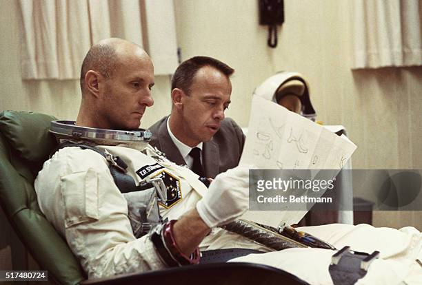 Cape Kennedy, Florida, USA. Gemini 6 Astronaut Tom Stafford studies a flight map before the December 15th Launch of the Gemini 6 mission. With him is...
